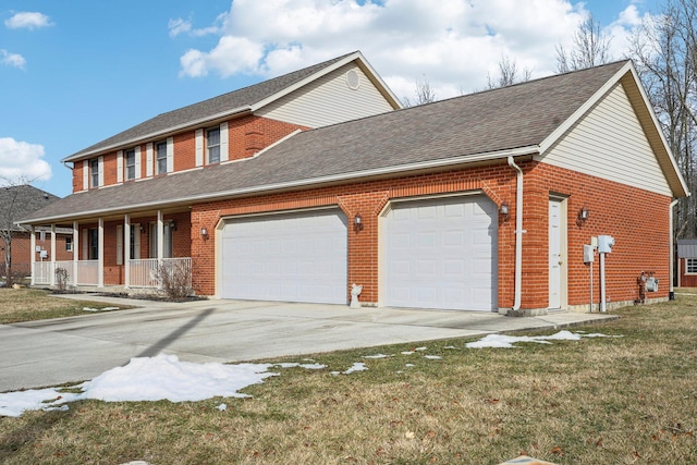 view of front of home with a garage, a front yard, and covered porch