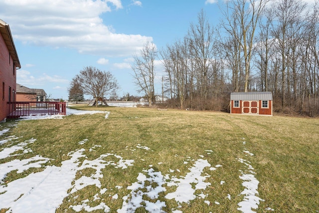 view of yard with a storage unit and a deck