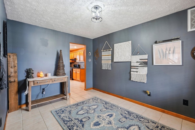 corridor featuring a textured ceiling and light tile patterned flooring