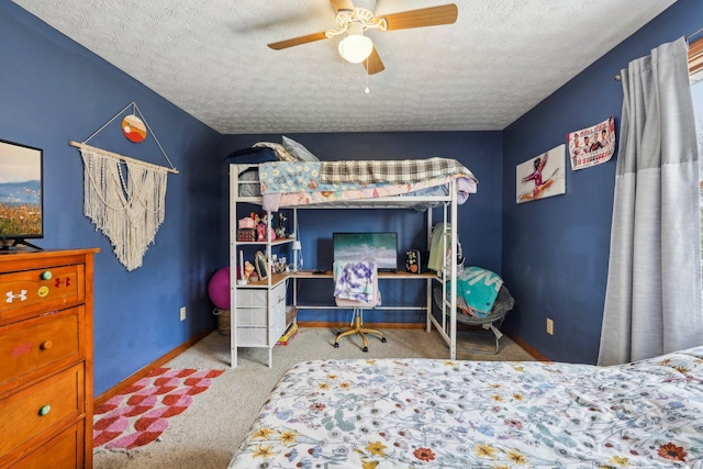 carpeted bedroom featuring ceiling fan and a textured ceiling