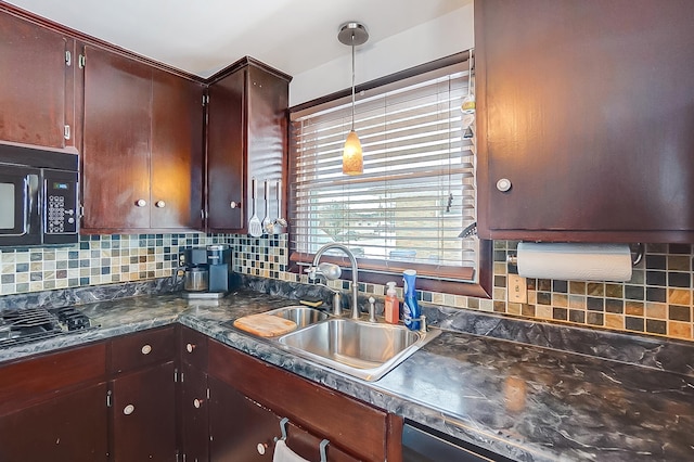 kitchen featuring sink, decorative light fixtures, black appliances, and decorative backsplash