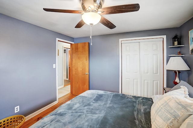 bedroom featuring wood-type flooring, a closet, and ceiling fan