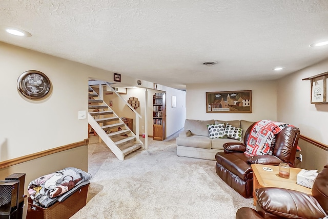 carpeted living room with a textured ceiling