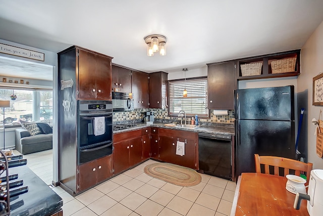 kitchen with sink, dark brown cabinets, black appliances, and plenty of natural light