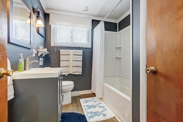 full bathroom with crown molding, vanity, hardwood / wood-style floors, and shower / bath combo