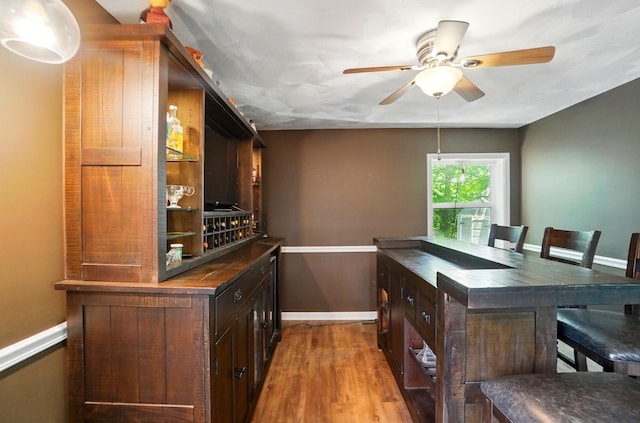 1370 Carpenter Rd, Bellbrook, OH 45305 - bar area with baseboards, a ceiling fan, and wood finished floors