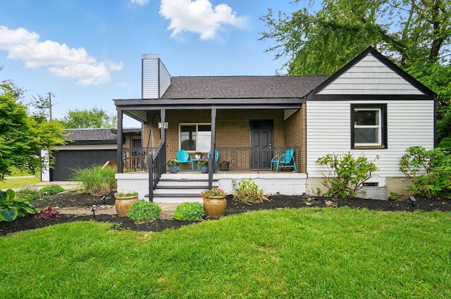 1370 Carpenter Rd, Bellbrook, OH 45305 - view of front of property featuring a porch, a front lawn, a chimney, brick siding, and roof with shingles