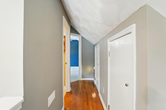 1370 Carpenter Rd, Bellbrook, OH 45305 - corridor featuring vaulted ceiling, wood finished floors, and baseboards