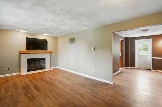 1370 Carpenter Rd, Bellbrook, OH 45305 - unfurnished living room with a tiled fireplace, wood finished floors, and baseboards