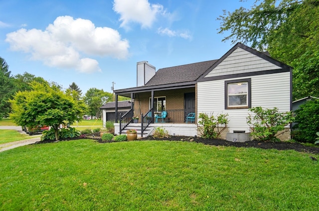 1370 Carpenter Rd, Bellbrook, OH 45305 - rear view of property featuring a porch, a yard, a chimney, and a shingled roof