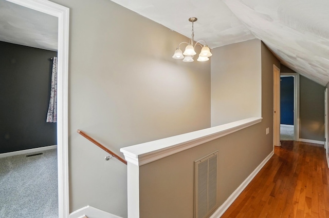1370 Carpenter Rd, Bellbrook, OH 45305 - hall featuring vaulted ceiling, baseboards, a chandelier, wood finished floors, and an upstairs landing