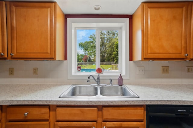 1370 Carpenter Rd, Bellbrook, OH 45305 - kitchen with black dishwasher, a sink, light countertops, and decorative backsplash