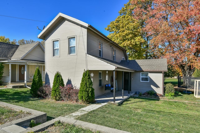 view of front facade featuring a front lawn and a patio