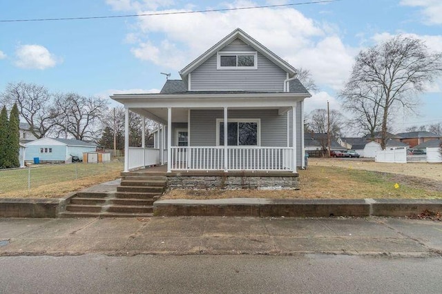 view of front facade featuring covered porch and a front yard