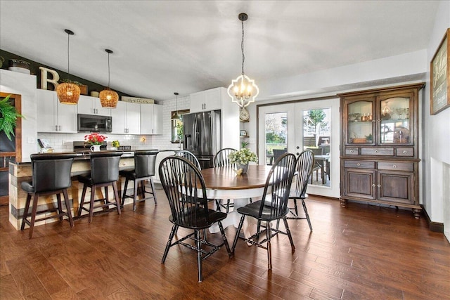 dining area featuring a wealth of natural light, french doors, a chandelier, and dark wood-type flooring