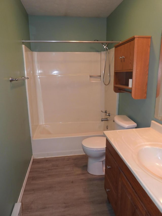 421 Summit St, Sidney, OH 45365 - bathroom featuring toilet, a baseboard heating unit, wood finished floors, bathing tub / shower combination, and vanity