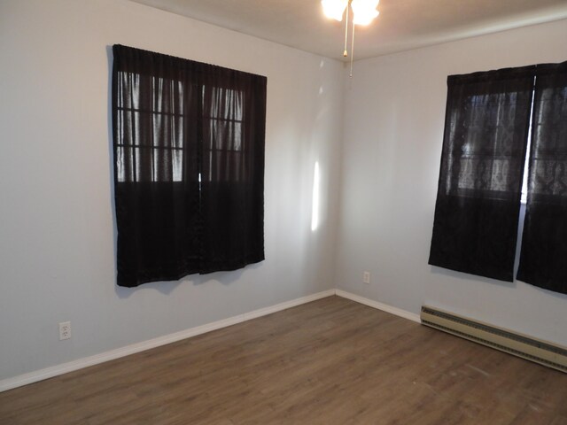 421 Summit St, Sidney, OH 45365 - unfurnished room featuring ceiling fan, wood finished floors, baseboards, and a baseboard radiator