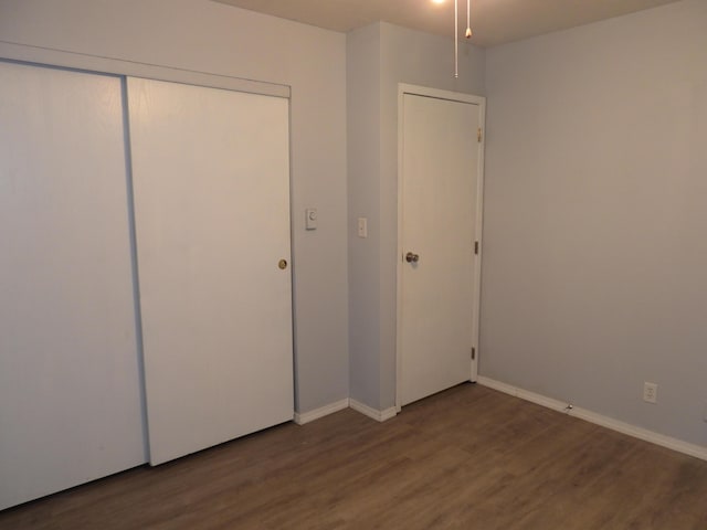 421 Summit St, Sidney, OH 45365 - unfurnished bedroom featuring a closet, baseboards, and wood finished floors