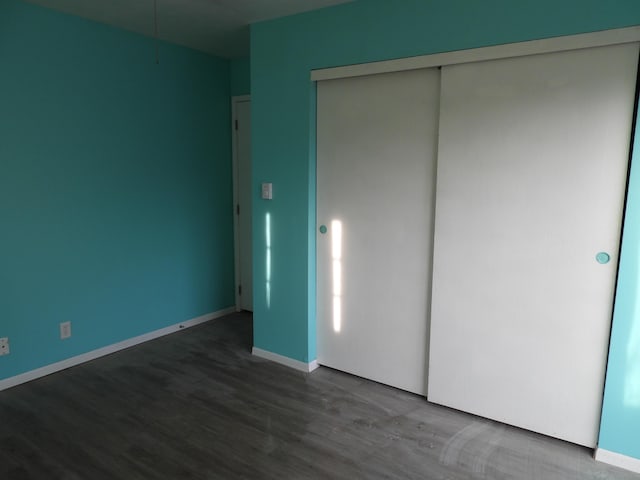 421 Summit St, Sidney, OH 45365 - unfurnished bedroom featuring wood finished floors, a closet, and baseboards