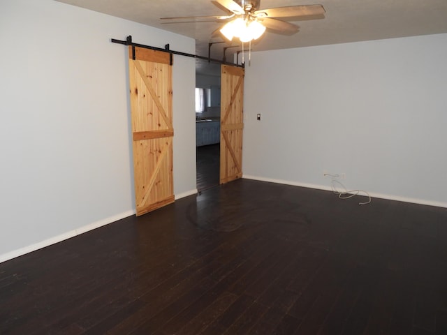 421 Summit St, Sidney, OH 45365 - empty room with baseboards, a ceiling fan, a barn door, and wood finished floors