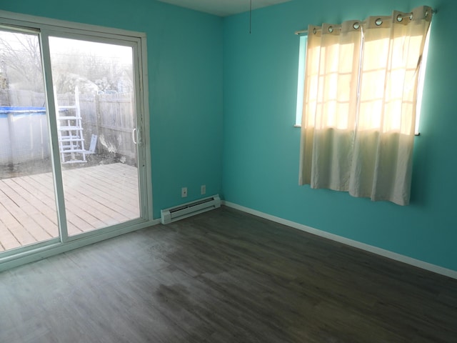 421 Summit St, Sidney, OH 45365 - unfurnished room featuring plenty of natural light, a baseboard heating unit, and dark wood-type flooring