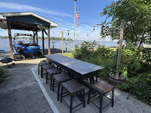 9029 Maple St, Huntsville, OH 43324 - view of patio / terrace featuring boat lift, a water view, and a dock