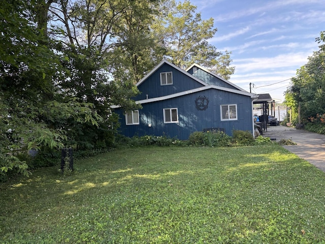 9029 Maple St, Huntsville, OH 43324 - view of property exterior with a lawn