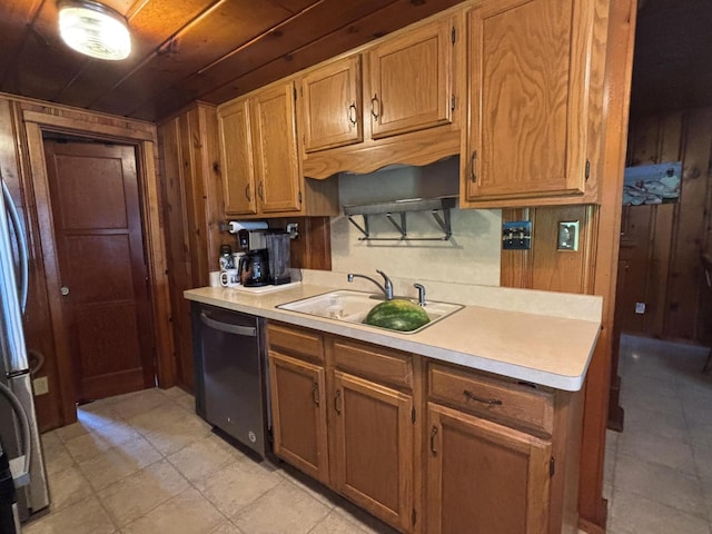 9029 Maple St, Huntsville, OH 43324 - kitchen with dishwasher, light countertops, wooden walls, brown cabinets, and light tile patterned floors