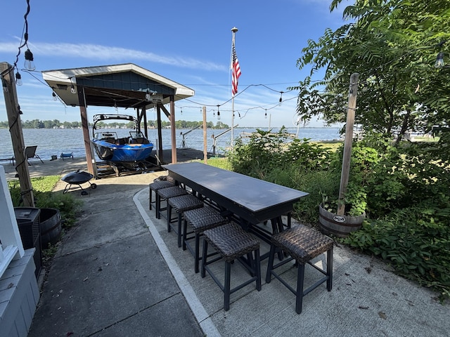 9029 Maple St, Huntsville, OH 43324 - view of patio / terrace featuring boat lift, a boat dock, and a water view