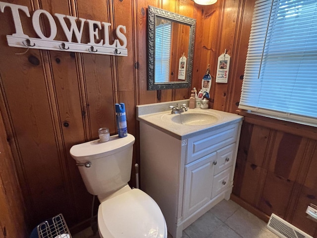 9029 Maple St, Huntsville, OH 43324 - bathroom with vanity, wood walls, and tile patterned flooring
