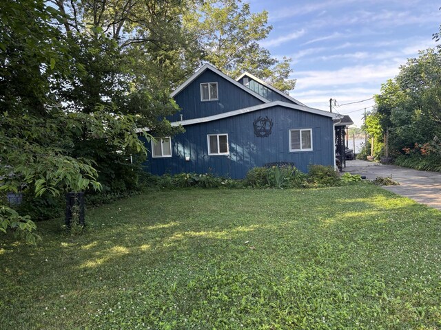 9029 Maple St, Huntsville, OH 43324 - view of property exterior with a lawn
