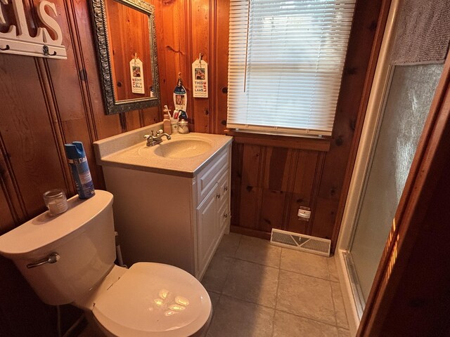9029 Maple St, Huntsville, OH 43324 - bathroom with vanity, tile patterned flooring, wood walls, and a shower with door