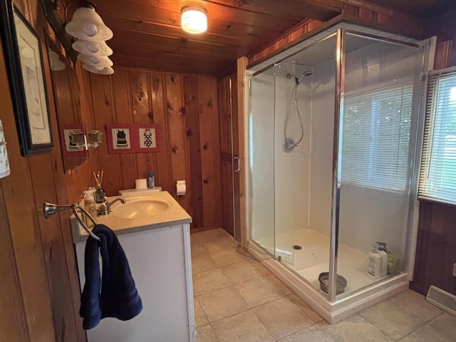 9029 Maple St, Huntsville, OH 43324 - full bath featuring a stall shower, wooden walls, wood ceiling, vanity, and tile patterned flooring