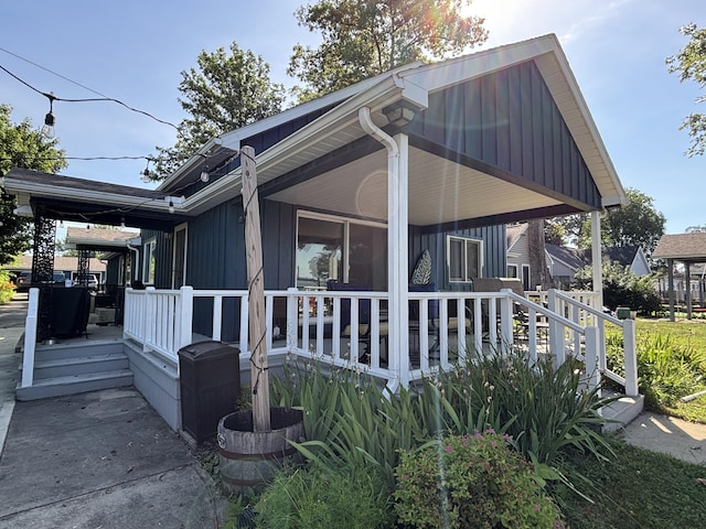 9029 Maple St, Huntsville, OH 43324 - view of home's exterior with a deck and board and batten siding