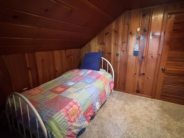 9029 Maple St, Huntsville, OH 43324 - bedroom with vaulted ceiling, wooden walls, and carpet floors