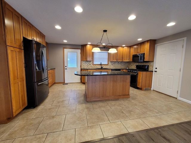 kitchen with fridge with ice dispenser, a sink, stainless steel microwave, tasteful backsplash, and gas stove