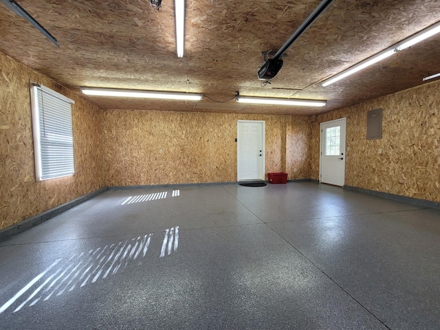 garage featuring electric panel and a garage door opener