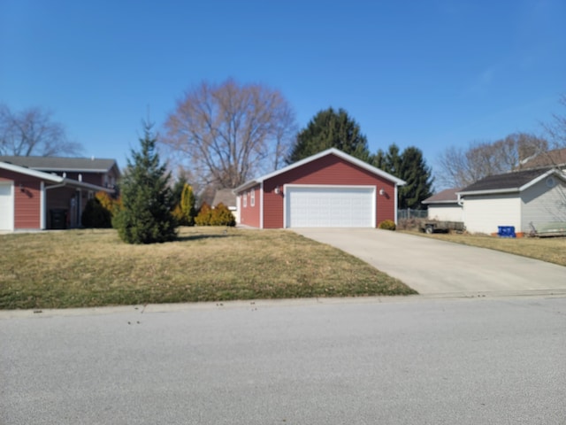 exterior space with a garage, an outbuilding, and a front lawn