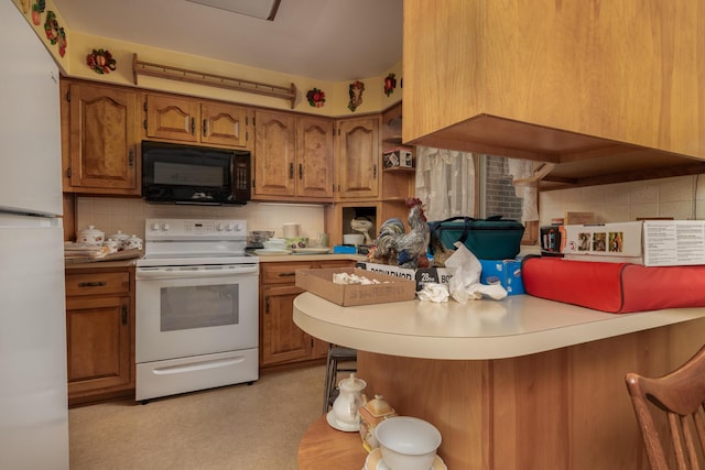 106 Westview Dr, Arcanum, OH 45304 - kitchen featuring white appliances, brown cabinetry, backsplash, and a kitchen bar