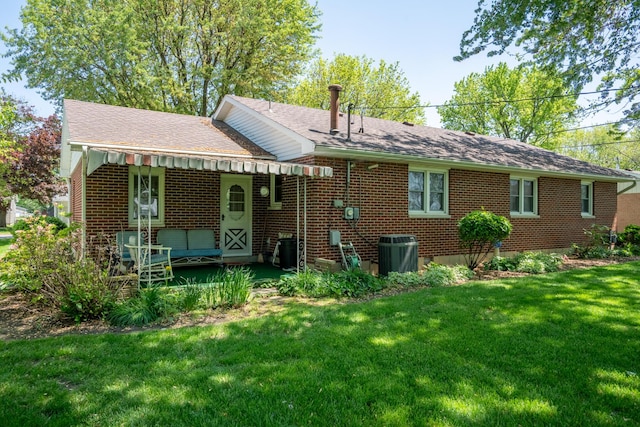 106 Westview Dr, Arcanum, OH 45304 - rear view of house featuring a lawn, brick siding, central AC unit, and a shingled roof