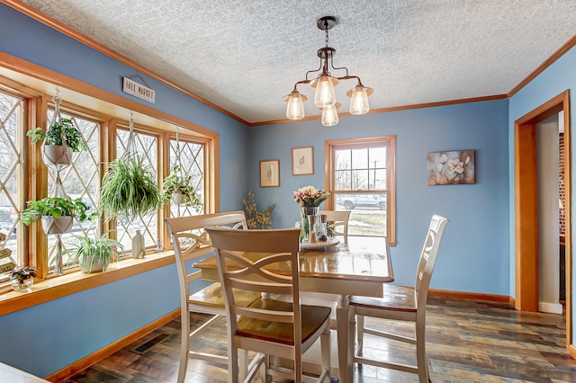 dining room with baseboards, wood finished floors, an inviting chandelier, a textured ceiling, and crown molding