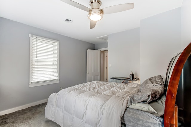 carpeted bedroom with baseboards, visible vents, and a ceiling fan