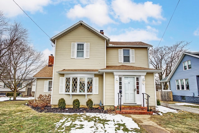 traditional home with a shingled roof, a chimney, and fence