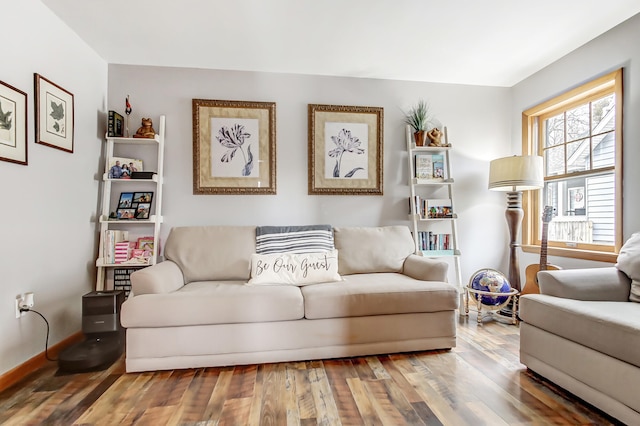 living area featuring hardwood / wood-style floors and baseboards