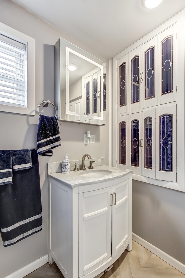 bathroom with vanity and baseboards