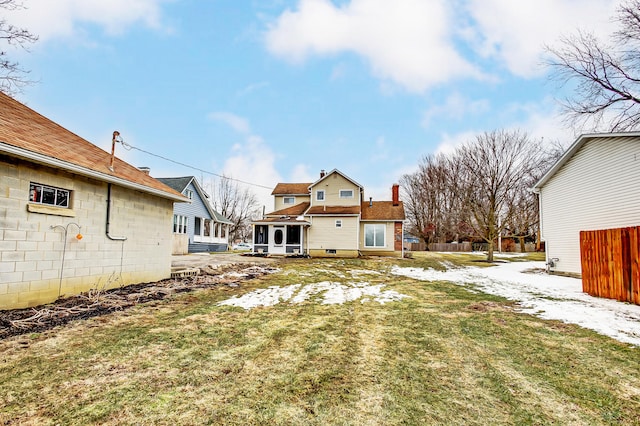 back of house with a yard and fence