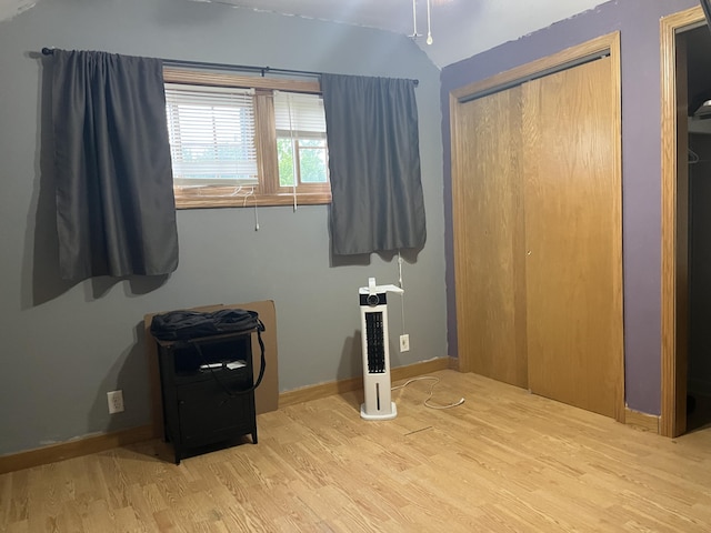 320 E Anthony St, Celina, OH 45822 - unfurnished bedroom featuring wood finished floors, lofted ceiling, a closet, and baseboards