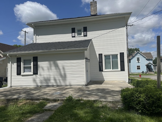 301 Plumvalley St, Bellefontaine, OH 43311 - rear view of property featuring a chimney and a patio