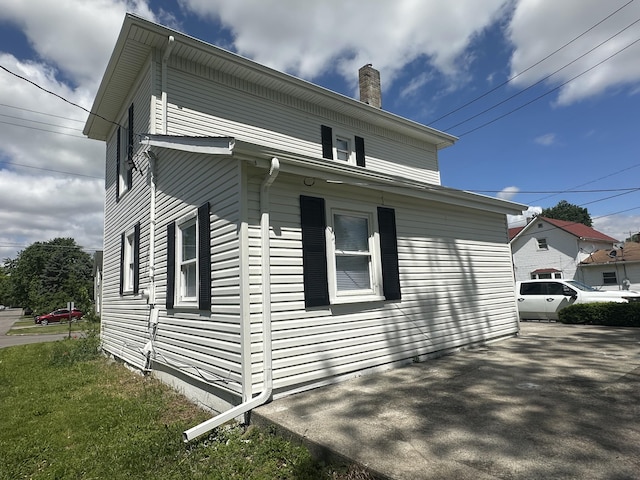 301 Plumvalley St, Bellefontaine, OH 43311 - view of home's exterior featuring a chimney