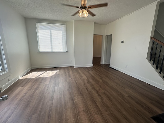 301 Plumvalley St, Bellefontaine, OH 43311 - unfurnished living room with ceiling fan, plenty of natural light, a textured ceiling, dark wood finished floors, and stairs